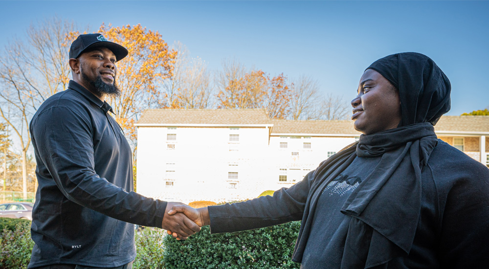 Fully Loaded Junk Removal & Dumpster Rental Expert Shaking Hands with Happy Customer